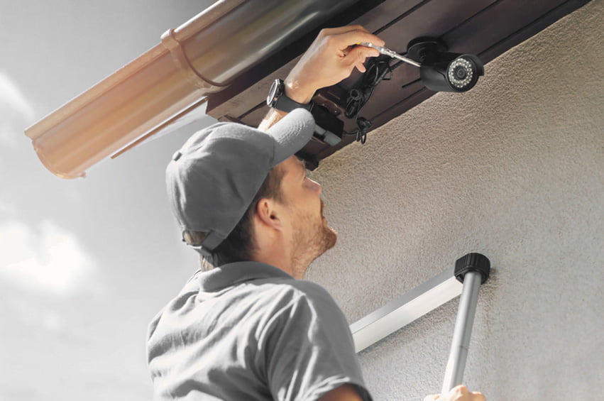 man repairing security system