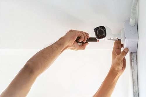 Expert technician repairing a 4K home CCTV camera to restore unmatched surveillance quality.