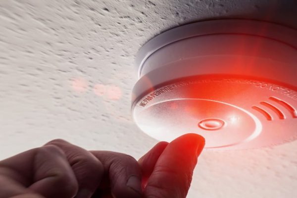 hand checking commercial fire alarms