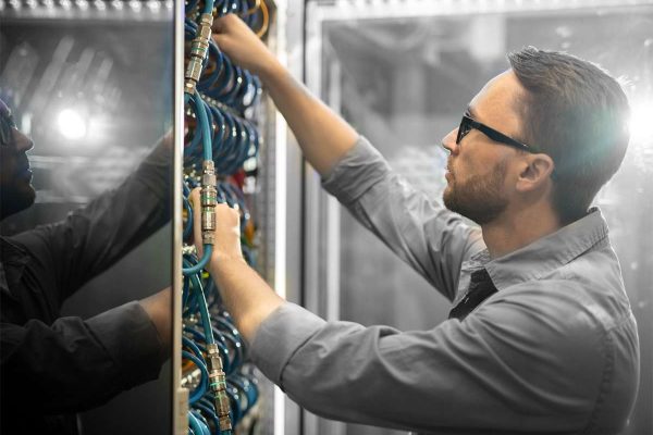 electrician fixing cables on panel board